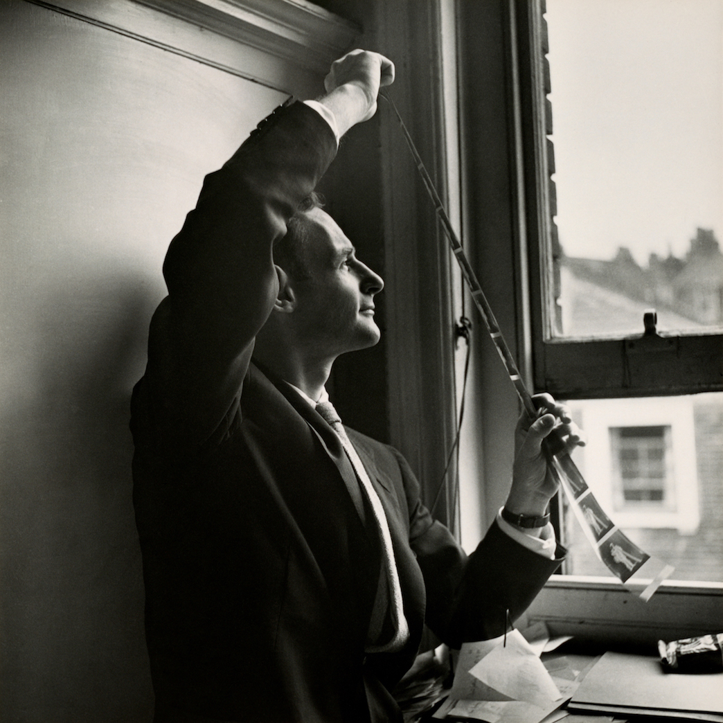 Irving Penn reviewing camera negatives for Chimney Sweep, London, 1950. Gelatin silver print. © The Cecil Beaton Studio Archive at Sotheby’s